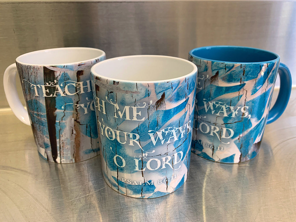 "Teach Me" on white and blue mugs 